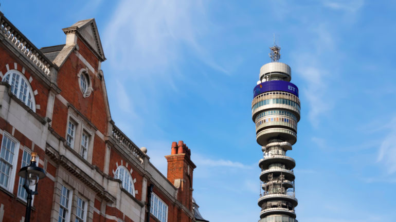 The sun shining on the BT Tower in central London (England), among the buildings of Fitzrovia; BT's Digital Voice Service