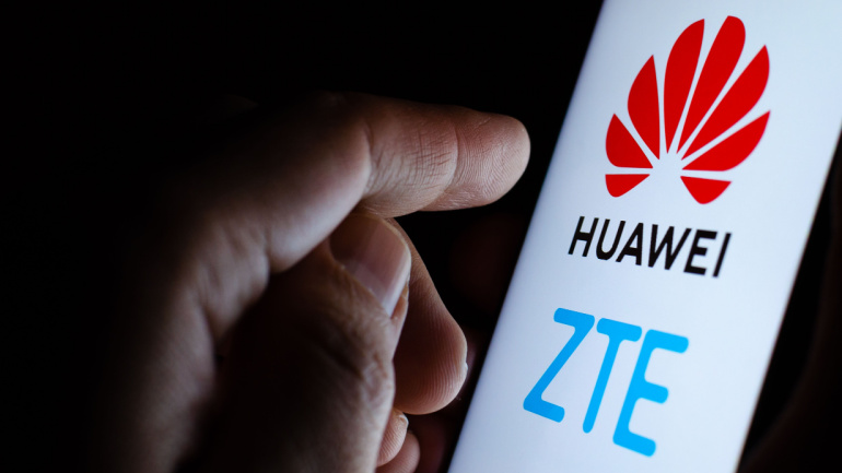 Stone, Staffordshire / United Kingdom -November 24, 2019: Huawei and ZTE logos on a smartphone and a user touching the screen. Concept photo for the news on Chinese suppliers of 5G networks telecom equipment.