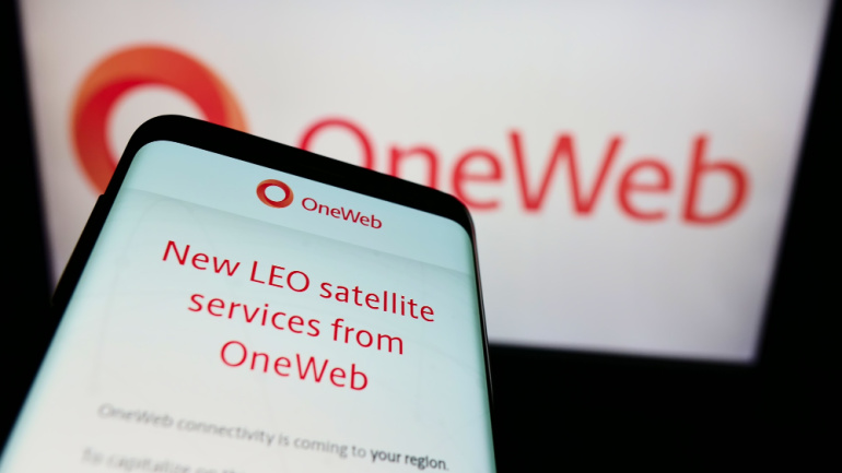 Smartphone with website of satellite company Network Access Associates (OneWeb) on screen in front of logo. Focus on top-left of phone display. Unmodified photo. Maritime connectivity satellite.