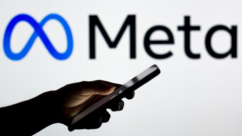 meta logo and mobile phone