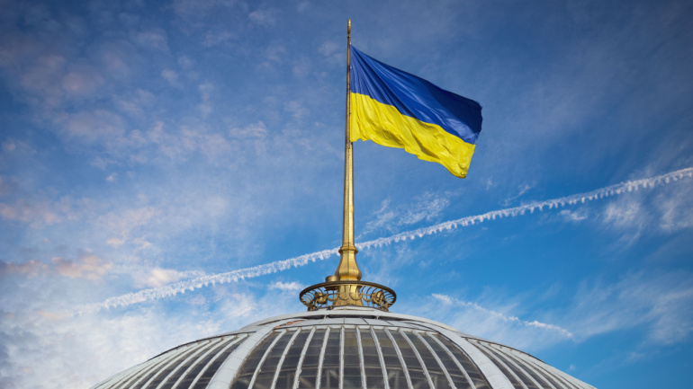View onthe flag on the top of Ukrainian parliament called Verkhovna Rada in Kiev. Veon Ukraine